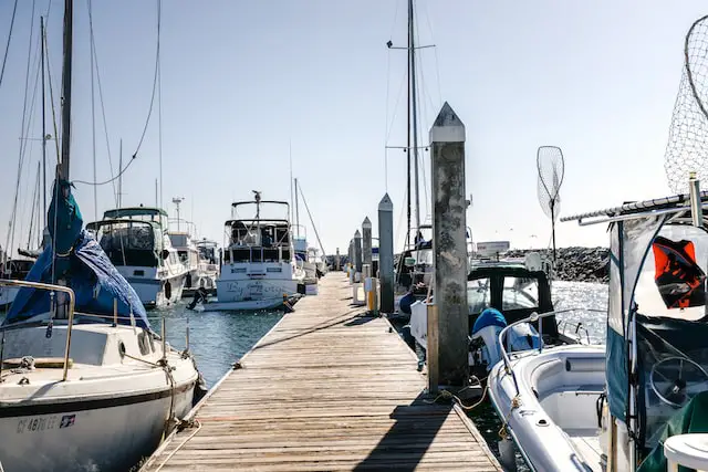 Which of the following is recommended when docking your boat? A. Remove all slack in your lines once you are tied up. B. Put out fenders after you are secured to the dock. C. Use full speed to maintain maneuverability. D. Use lines and cleats to help maneuver your boat.